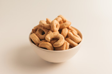 Taralli is a traditional Italian appetizer, similar to drying or bagels, typical of the cuisine of Sicily and Calabria. Bagel on a white background in a bowl.
