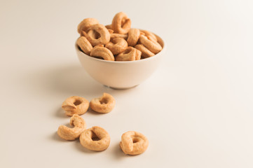 Taralli is a traditional Italian appetizer, similar to drying or bagels, typical of the cuisine of Sicily and Calabria. Bagel on a white background in a bowl.