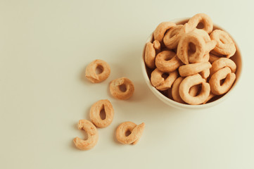 Taralli is a traditional Italian appetizer, similar to drying or bagels, typical of the cuisine of Sicily and Calabria. Bagel on a white background in a bowl.