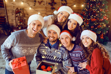 Friends with gifts celebrating Christmas.