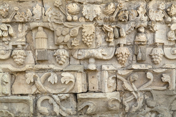Antique bas-relief with monograms on the base of the church