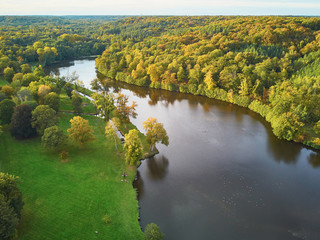 Scenic aerial view of a lake in autumn forest in northern France - obrazy, fototapety, plakaty
