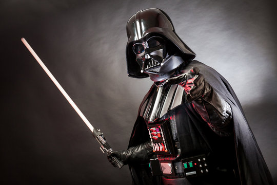 SAN BENEDETTO DEL TRONTO, ITALY. MAY 16, 2015. Portrait of Darth Vader costume replica with grab hand and his sword . Darth Vader or Dart Fener is a fictional character of Star Wars saga.