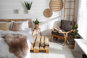 Stylish modern bedroom interior with  comfortable armchair