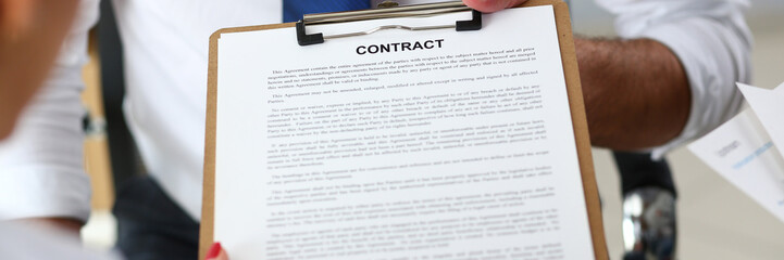 Male arm offer contract form on clipboard pad