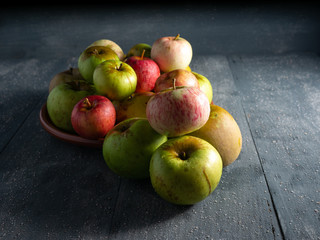 apples on a plate and dark background