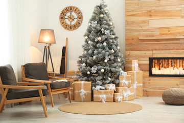 Stylish room interior with beautiful Christmas tree and gift boxes
