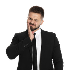 Businessman suffering from acute toothache on white background