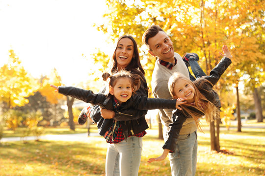 Happy Family With Little Children In Sunny Park. Autumn Walk