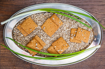 wheat crackers shooted with different  vegetables,groats,honey,seeds,salt on different surfaces