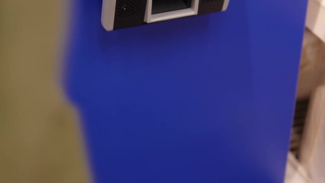 Movement of a woman holding goods in her hands to check prices on a barcode scanner in a store