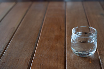 A refreshing glass of cold water laid on a wooden table