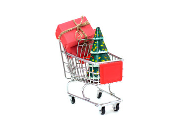 Christmas gifts in a supermarket trolley on white background. Black Friday and Cyber Monday