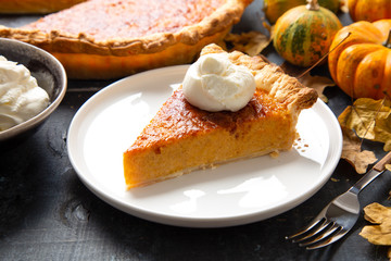 Portion of homemade thanksgiving pie with whipped cream