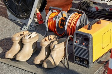 Electrically insulated boots protect worker from risks of pace voltage when there is line-to-ground...