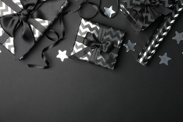 Gift boxes with bow on black background. Black Friday sale