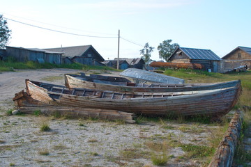 Broken wooden boat on the shore of the White sea. Solovetsky Islands, Russia