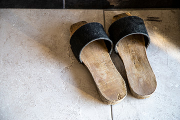 Entourage wooden slippers on the floor