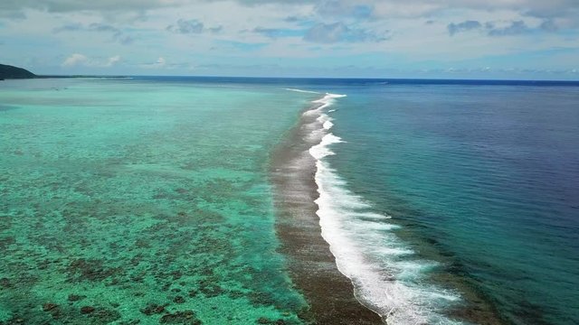 Aerial: A Reef Break Right off the Island of Moorea in the South Pacific Ocean