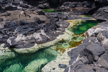 Fototapeta na wymiar Los Charcones area with beautiful green and blue pools of sea water