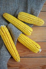 Fresh corn on a wooden background.