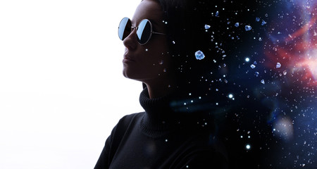 Double exposure of female face in glasses and galaxy. Abstract woman portrait. Digital art.