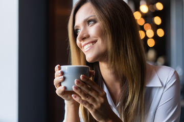 woman drinking coffee in the morning at restaurant