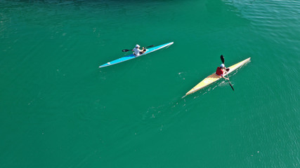 Aerial drone photo of sport canoe competing in tropical exotic green lake