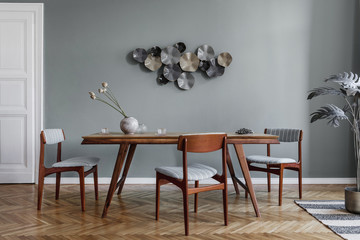 Modern dining room interior with glamour wooden table , stylish chairs and design decoration....