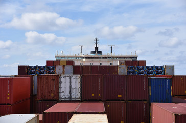 Large, fully loaded, cargo container ship sailing through the ocean. View from the forward mast on...