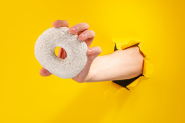 Hand giving a white donut