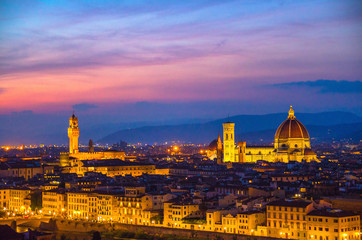 Fototapeta na wymiar Top aerial panoramic evening view of Florence city with Duomo Cattedrale di Santa Maria del Fiore cathedral and Palazzo Vecchio palace at night dusk twilight, city lights, blue sky, Tuscany, Italy