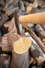 Ax stuck in the stump. wooden stump in the forest. Deforestation man. Felled tree. Woodcutter's ax on the stump.