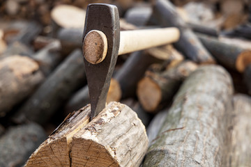 Ax stuck in the stump. wooden stump in the forest. Deforestation man. Felled tree. Woodcutter's ax on the stump.