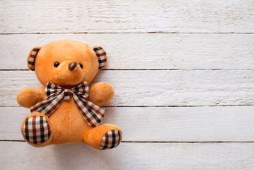 teddy bear on white wooden background, copy space.