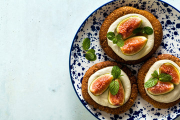 healthy gluten-free vegan cakes with sesame cookie base and cashew cream. with fresh figs. healthy cuisine