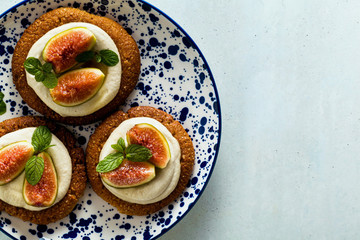 healthy gluten-free vegan cakes with sesame cookie base and cashew cream. with fresh figs. healthy cuisine