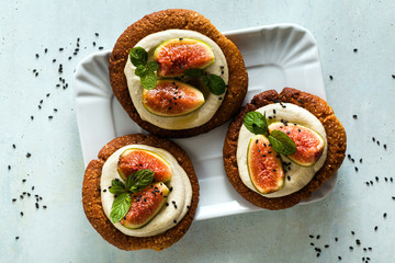 healthy gluten-free vegan cakes with sesame cookie base and cashew cream. with fresh figs. healthy cuisine