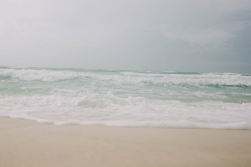 Beach with light blue water and white sand