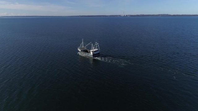 Orbiting Shot of a Boat Cruising the Ocean Revealing Open Water