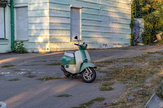 Light Green Scooter near house