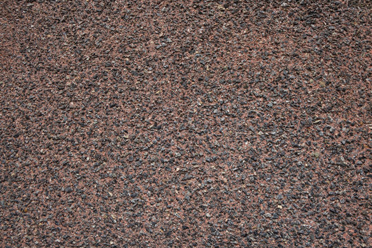 Aspalt texture, granite chips aggregate in asphalt, red as used for cycle path in UK