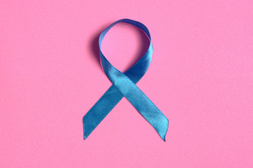 Blue ribbon on pink isolated background, international cancer prostate day concept, with copy space