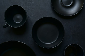 Culinary background with empty black tableware. Top view.