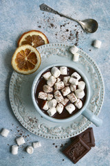 Homemade hot chocolate with orange and mini marshmallow .Top view with copy space.