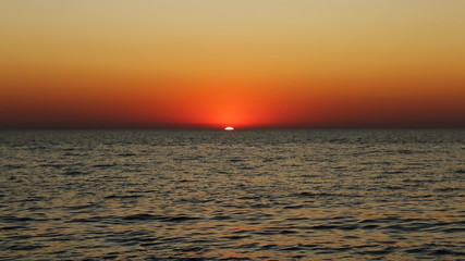 amazing sunset in the sea in red and dark colors