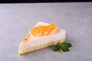  fresh cake with orange on a gray background