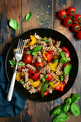 Whole wheat fusilli pasta with grilled vegetables. Top view with copy space.