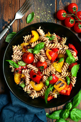 Whole wheat fusilli pasta with grilled vegetables. Top view with copy space.