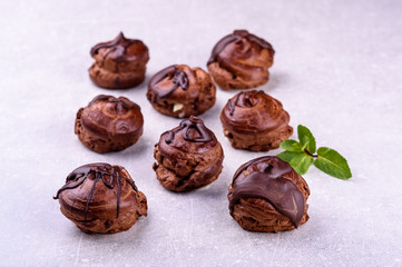  chocolate eclairs on a gray background in the kitchen12